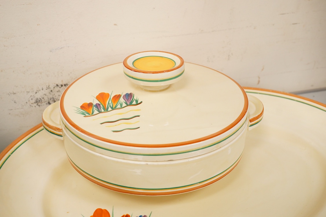 A Clarice Cliff ‘crocus pattern’ tureen and cover, jug, honey pot with cover and an oval meat platter - 43cm wide
